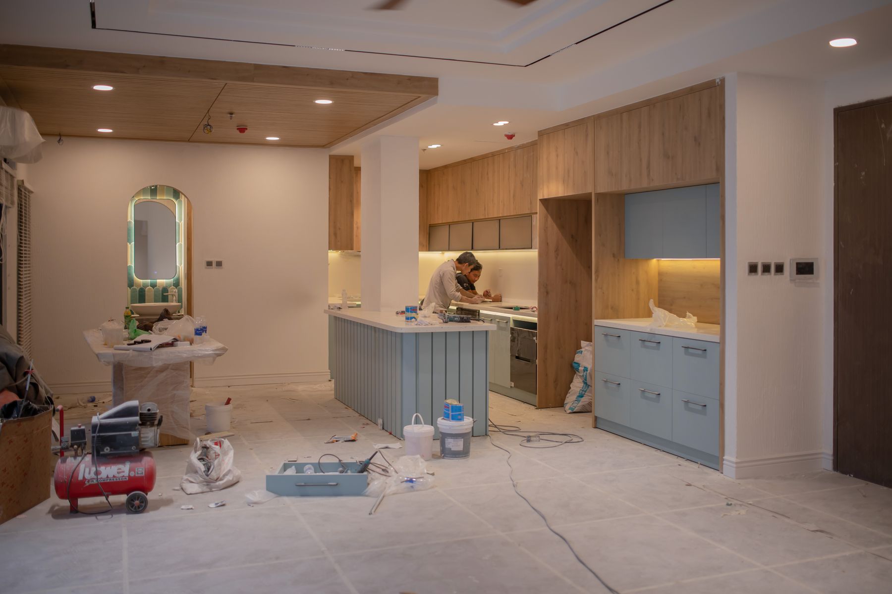 Contractors working around new countertops during a kitchen renovation